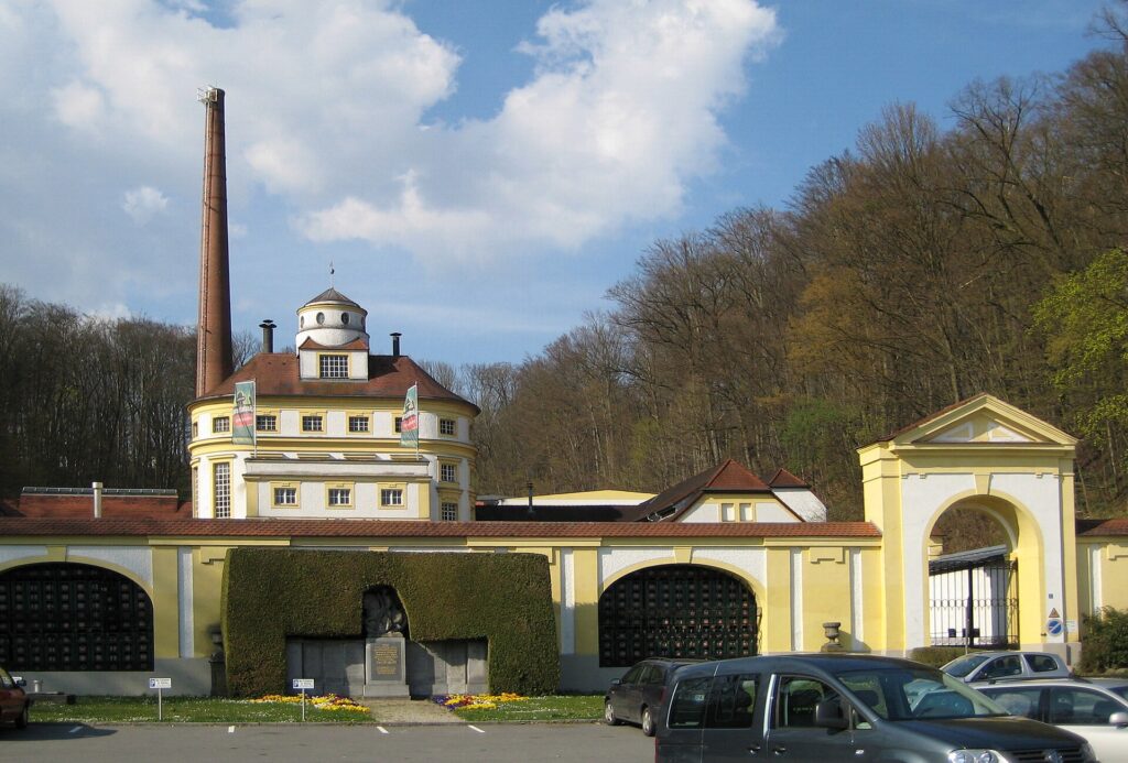 The yellow facade and chimney of the Hacklberg brewery in Passau